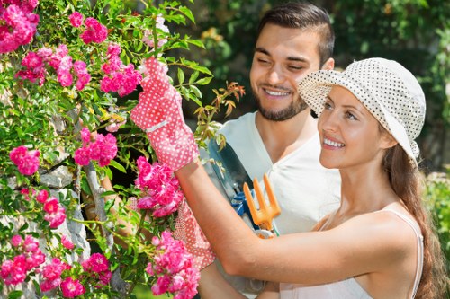 Professional landscapers working on a backyard project in Acton